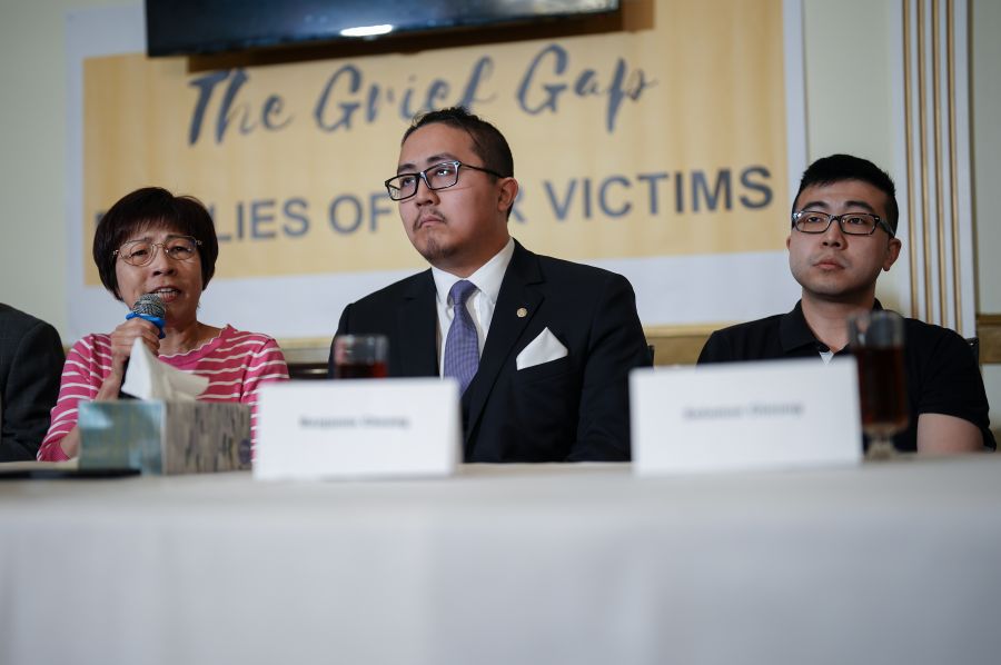 <who> Photo Credit: Canadian Press</who> Athens Cheung, left, speaks about her late husband Rev. Tom Cheung, who died in a fiery car crash at the Peace Arch border crossing in 2019, as their sons Benjamin Cheung, centre, and Solomon Cheung, right, listen during a family news conference with community advocates, in Richmond, Friday, May 9, 2025. 