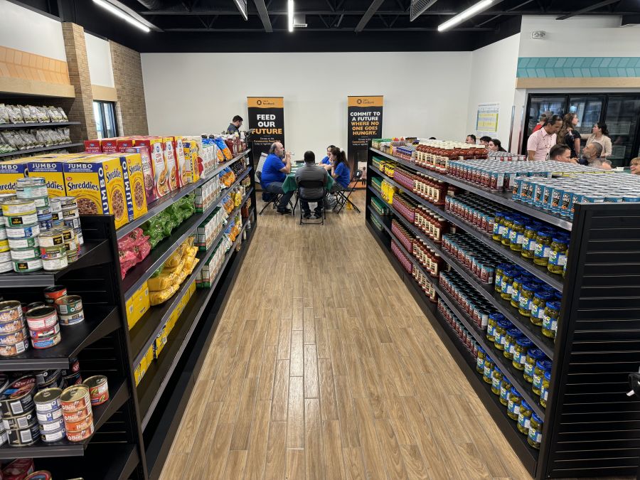 <who> Photo Credit: Canadian Press</who> The food bank in Regina opened a new location on Thursday, Aug. 15, 2024, using a model that allows clients to select their items, similar to shopping at a grocery store. The organization held the grand opening with donors, dignitaries and community members. 