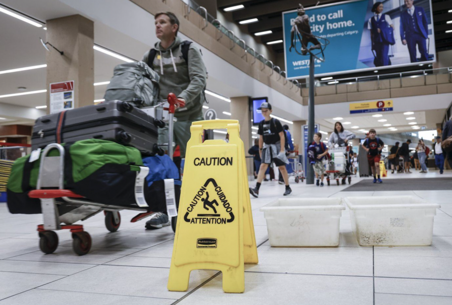 <who> Photo credit: Canadian Press </who> Travellers manoeuvre around buckets catching leaks as repairs are underway at the Calgary International Airport after parts of its domestic terminal building were closed late Monday due to damage caused by hail and heavy rainfall, in Calgary, Tuesday, Aug. 6, 2024.