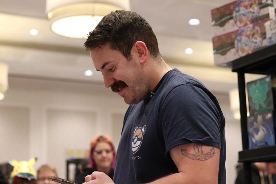 <who> Photo Credit: NowMedia/Corvin Vaski</who> Ouellet using a phone to check a card at a recent show.