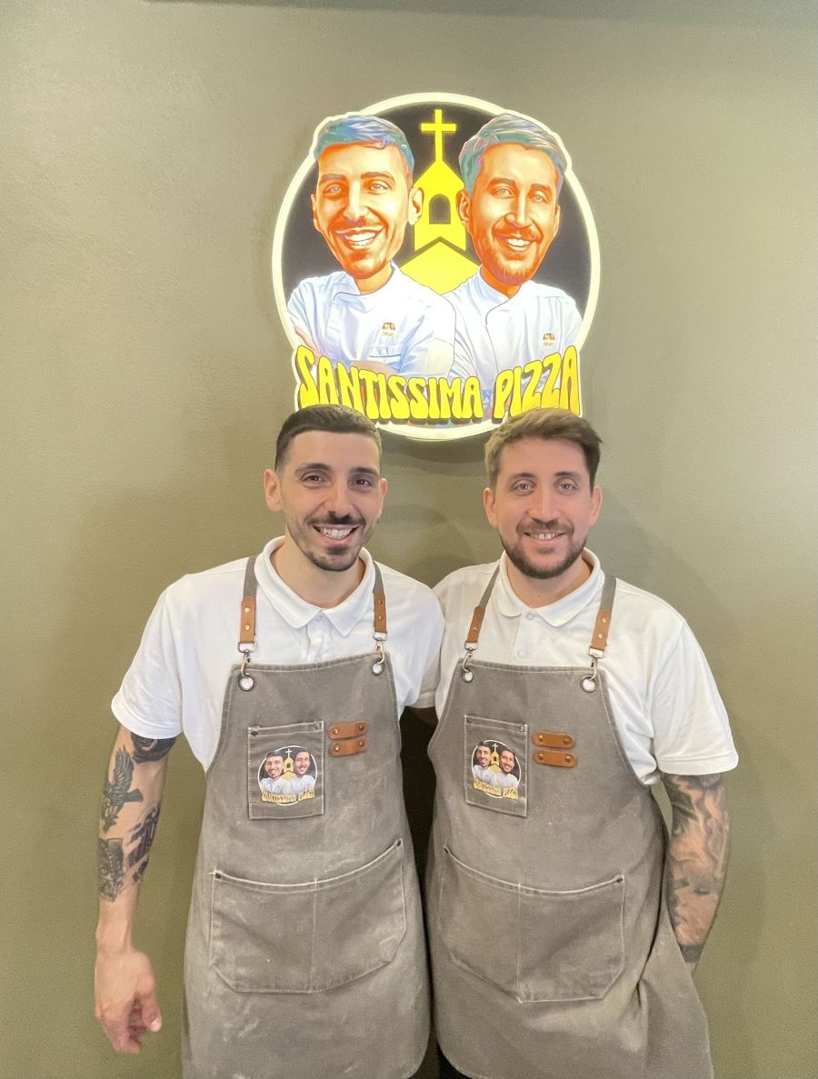 </who>Owners Savio Costagliola, left, and Sasy Serino with their ecclesiastical-themed business sign.
