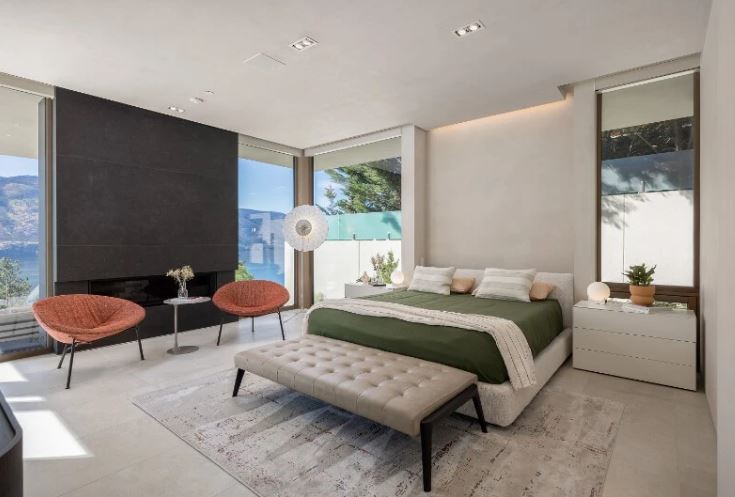 <who>Photo credit: Sotheby's</who>A black fireplace and a view in the master bedroom.