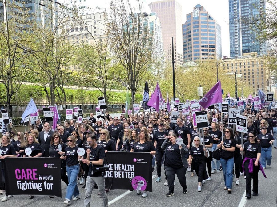 <who>Photo Credit: Local Journalism Initiative</who>Over 550 BCNU nurses and allied health-care workers rally in downtown Vancouver on April 30, 2026.