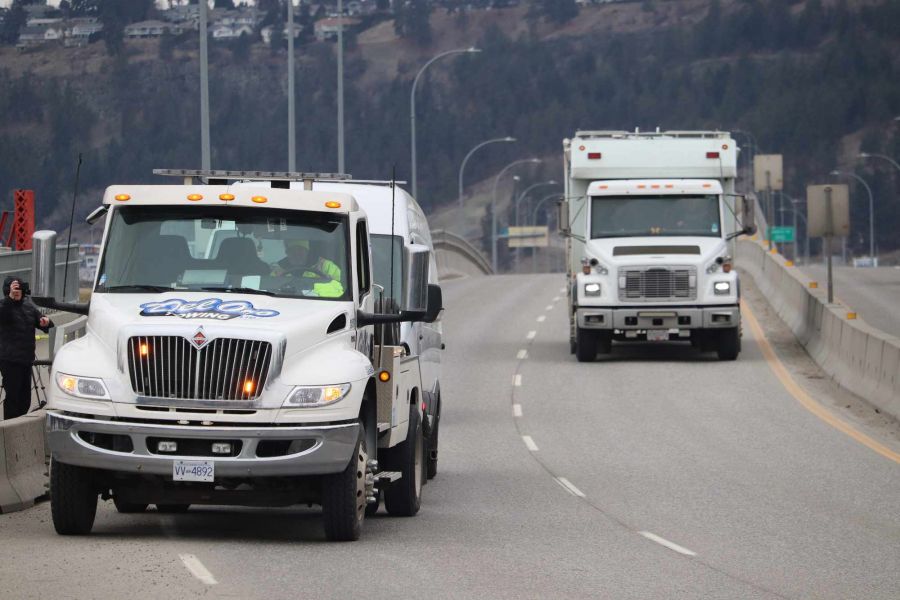 <who>Photo Credit: KelownaNow</who>The Lower Mainland Explosive Disposal Unit exits the bridge after completing the job.