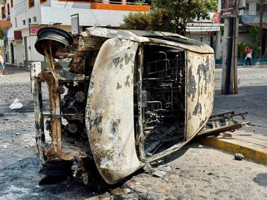 </who>Above, on its side and torched. Below, burned out pick-up truck