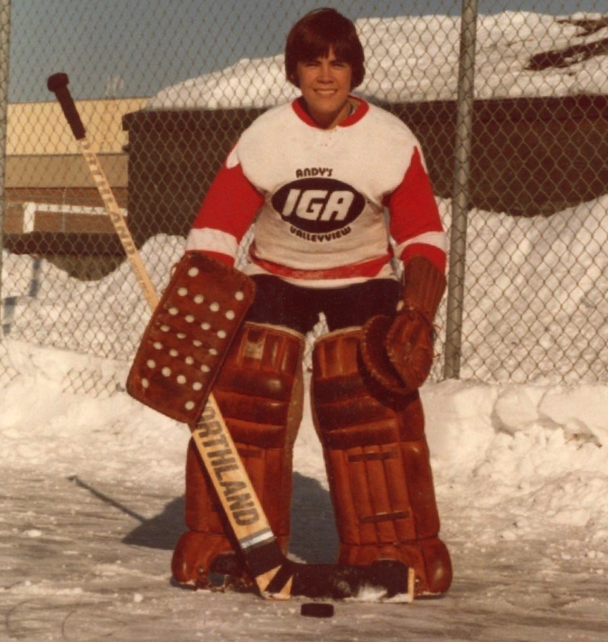 <who> Photo credit: Mark Carney </who> A young Mark Carney playing hockey.