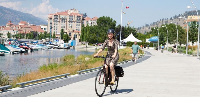 <who>Photo credit: City of Kelowna</who>A cyclist in Kelowna's Waterfront Park.