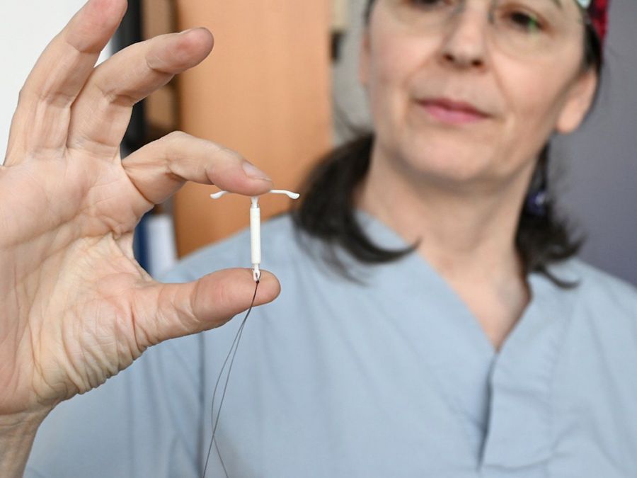 <who>Photo Credit: Michelle Gamage/Local Journalism Initiative</who>Dr. Renée Hall holds up a hormonal IUD at the Everywoman's Health Centre in Vancouver..