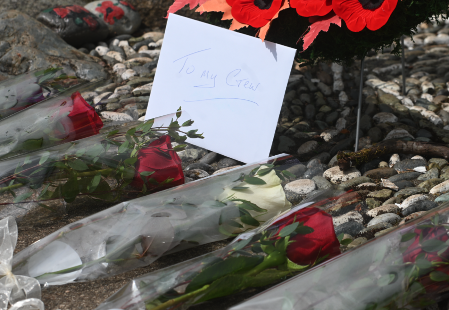 <who> Photo credit: Abby Luciano / North Shore News </who> One of the roses is white, representing Bob Reid as the only survivor of the plane crash in 1966.