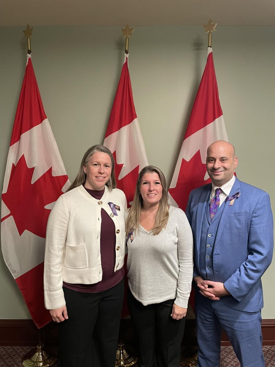 <who>Photo Credit: Facebook</who>Frank Caputo stands with Bailey McCourt's aunt and stepmom during a trip to Ottawa to support Bill C-225.