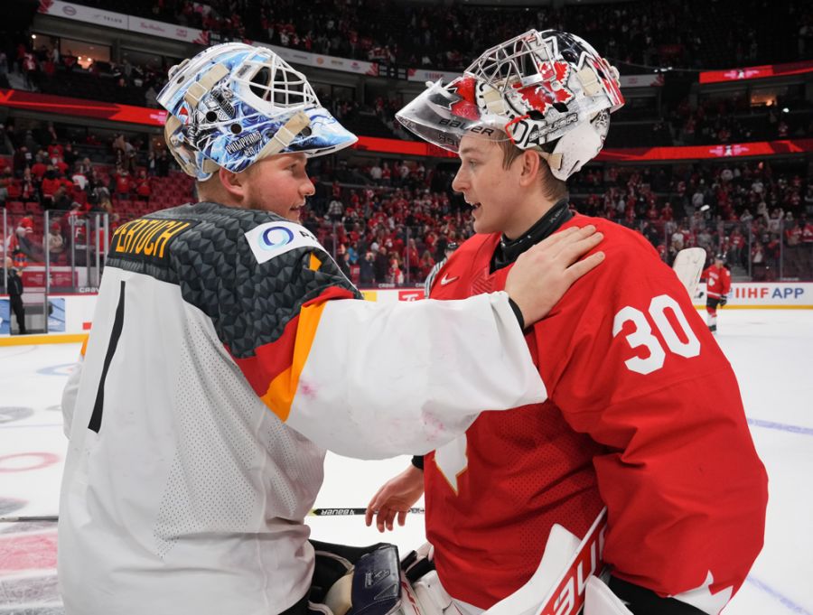 <who>Photo Credit: Hockey Canada</who>Carter George (R) and Nico Pertuch embrace following Sunday night's showdown between Canada and Germany.