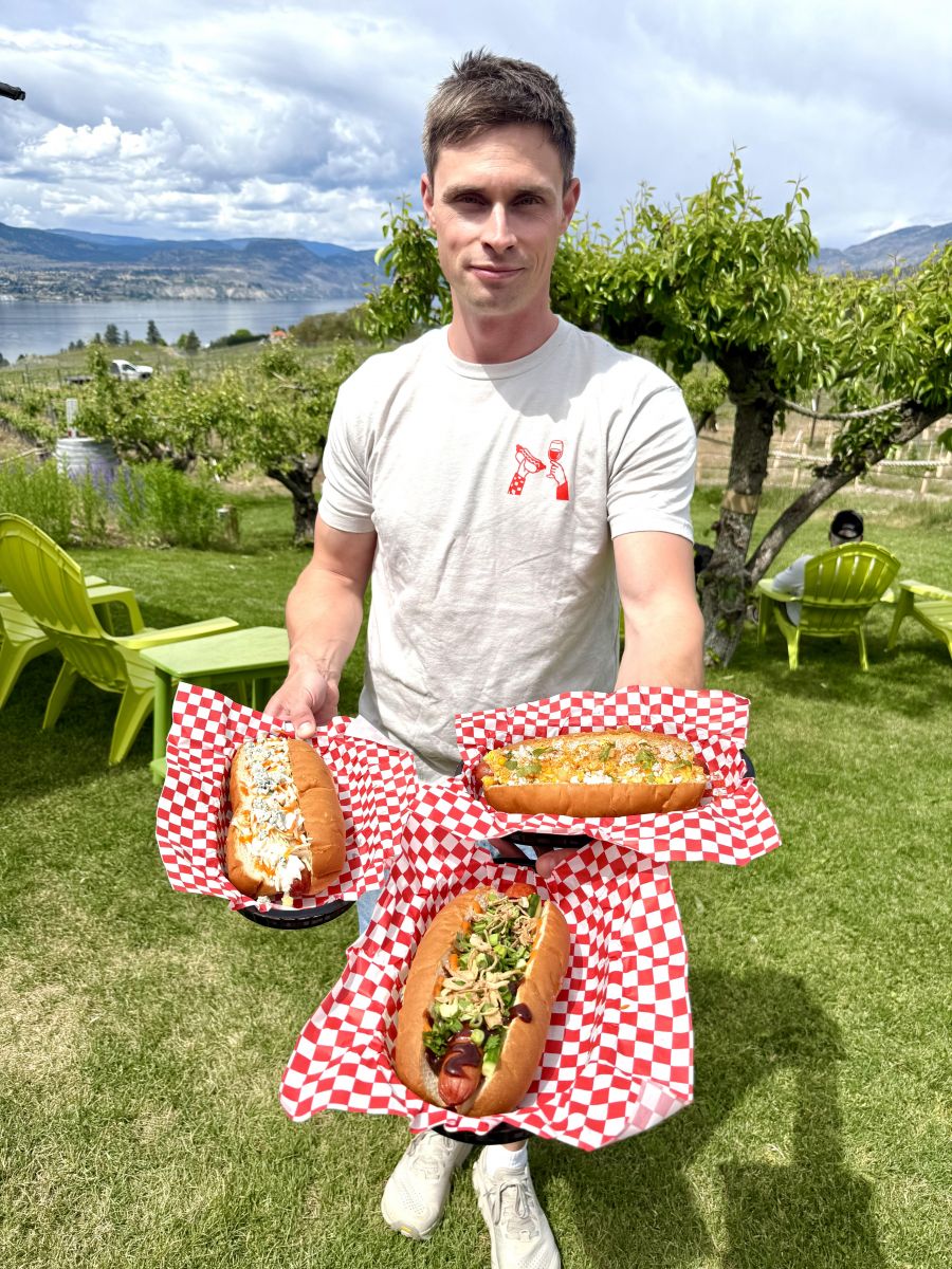 <who>Photo credits: Steve MacNaull/NowMedia Group</who>JoieFarm's hospitality manager Zach Wheeler shows off, clockwise from bottom, the Han Seoulo hot dog, The Tailgate and the Mexican street dog.
