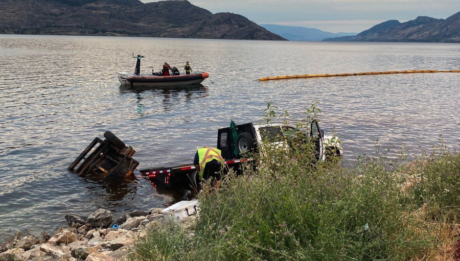 <who> Photo credit: BC government </who> The truck after it crashed into the lake.