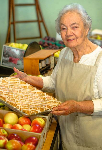 <who>Photo credit: The Davison Orchards Cookbook</who>Dora Davison, aka Nana, with her apple slice strudel.