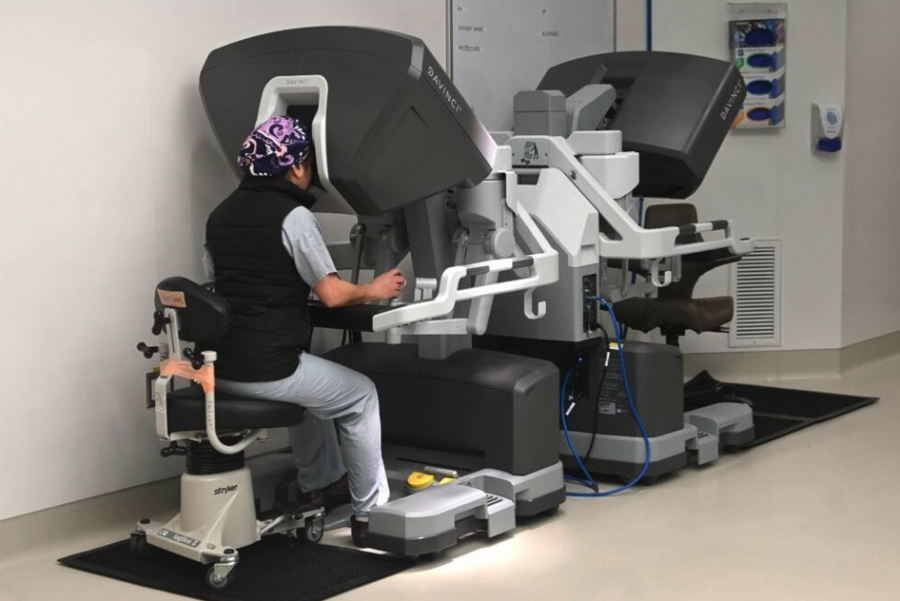 <who> Photo credit: Abby Luciano / North Shore News </who> Dr. Nava Aslani demonstrates how the console of the Da Vinci Xi Robotic Surgical System is used.