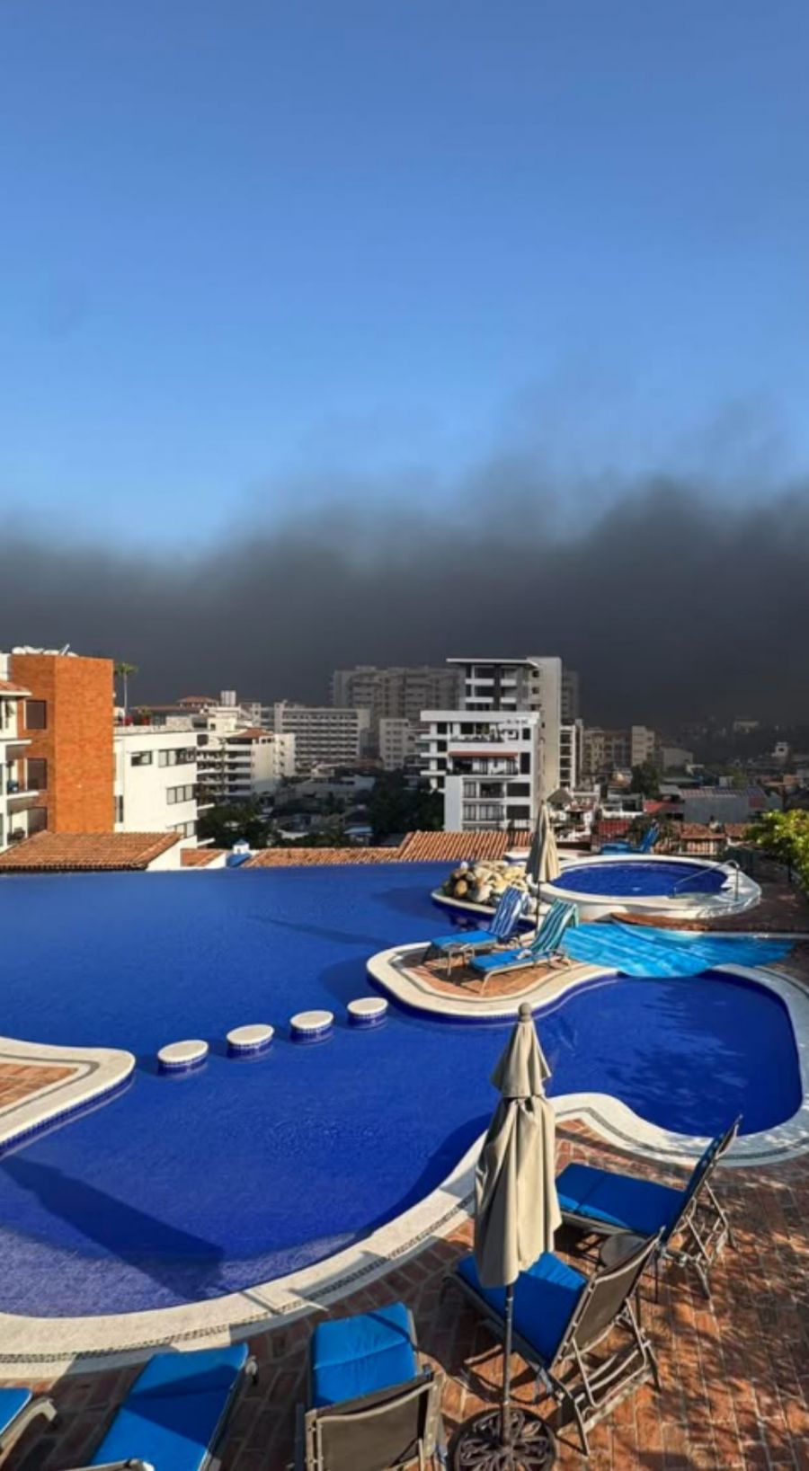</who>The view on Sunday from the pool at the complex where Brenda Bachmann is staying in Puerto Vallarta. I shows smoke in the distance in this photo from her Facebook.