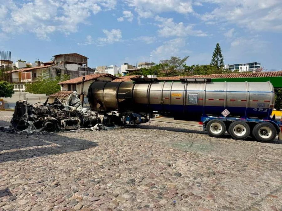 </who> Above, attempted to burn this tanker truck full of fuel. Below, this bus fire spread and gutted a real estate company in the ground floor of the adjacent building.