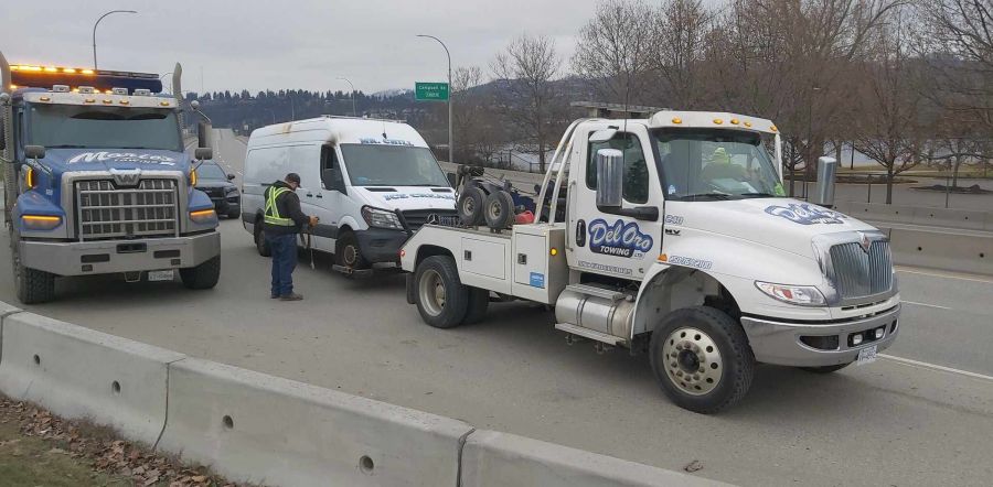 <who>Photo Credit: KelownaNow</who>The suspect van, which has the markings of an ice cream truck on its front side, is towed from the scene.