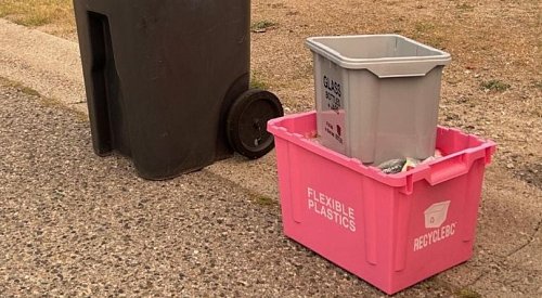 Pink and grey recycle boxes being delivered to Central Okanagan homes